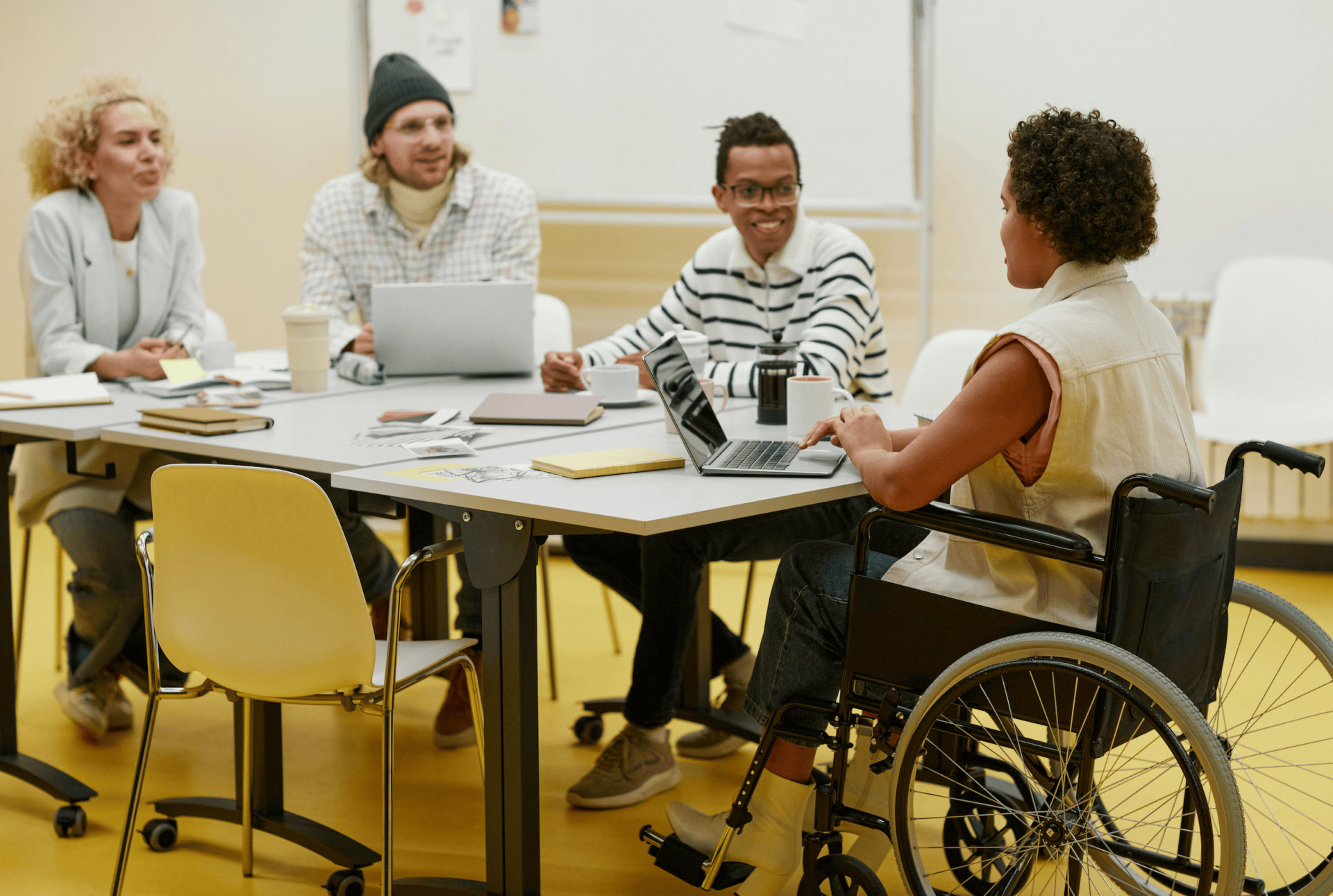 College students gathered around a table working together.